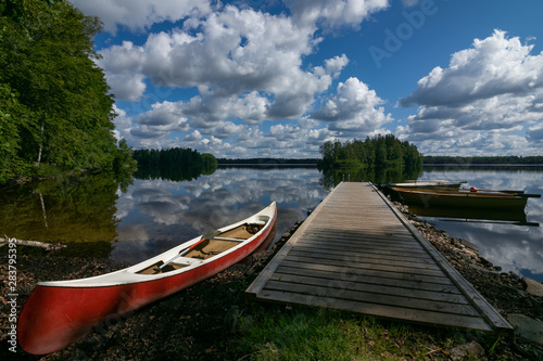 Fototapeta Naklejka Na Ścianę i Meble -  jetty and red canoe, Stora Hensjön lake, Tingsryd , Smaland, Sweden