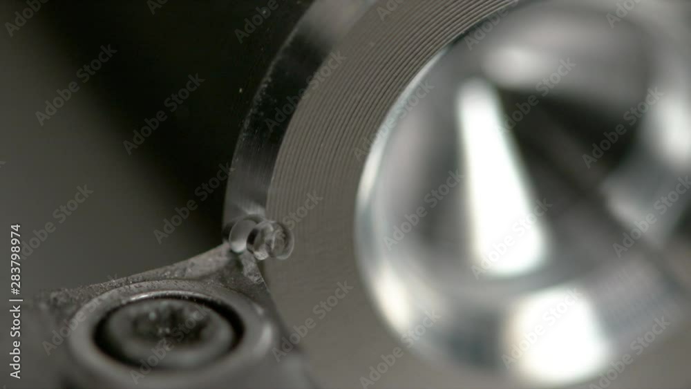SLOW MOTION, MACRO, DOF: Shiny twisted shavings are made as a CNC machine threads a workpiece. Detailed macro view of lathing equipment cutting into a small piece of aluminium. Automated metalwork SLOW MOTION, MACRO, DOF: Shiny twisted shavings are made as a CNC machine threads a workpiece. Detailed macro view of lathing equipment cutting into a small piece of aluminium. Automated metalwork