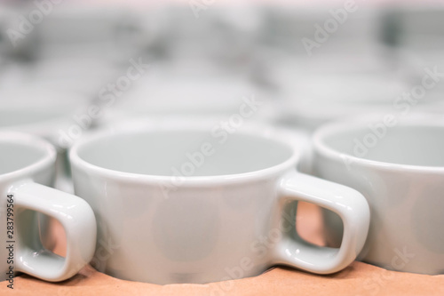 Closeup of White ceramic cup on the shelf.Closeup of Ceramic glass on the shelf.