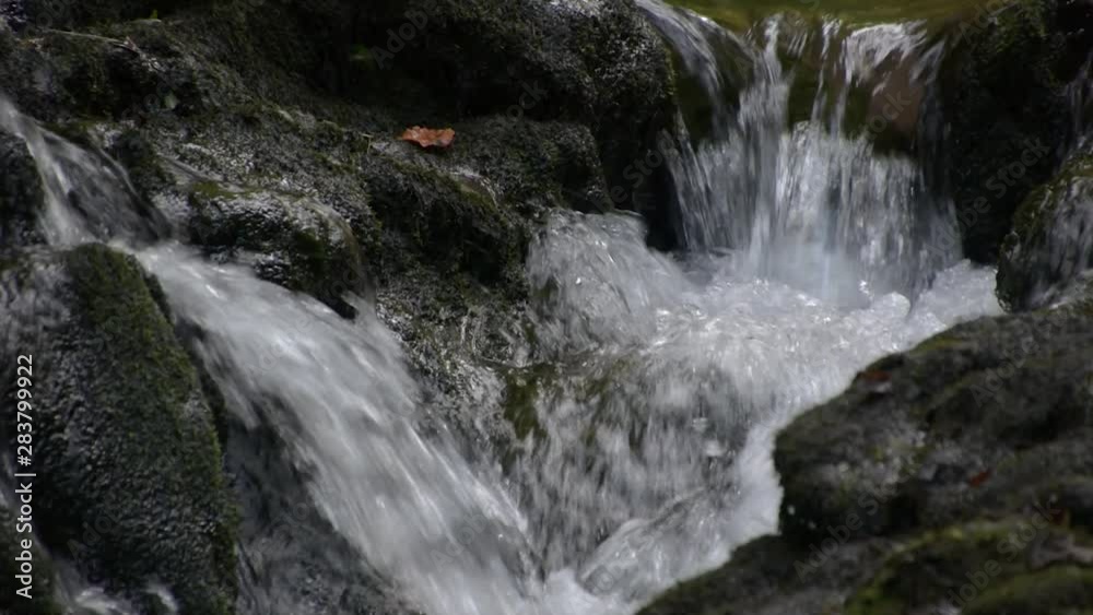 Waterfall stream of fresh water in scenic pristine natural environment Waterfall stream of fresh water in scenic pristine natural environment