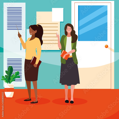interracial female teachers couple in school corridor