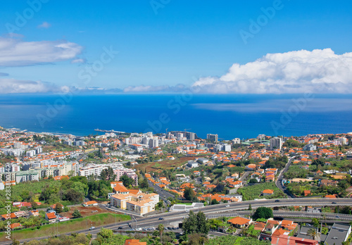 Fototapeta Naklejka Na Ścianę i Meble -  Funchal and Atlantic ocean panormic view from The Pico dos Barcelos Viewpoin (MIRADOURO PICO DOS BARCELOS) in Funchal city, Madeira island, Portugal in summer sunny day 
