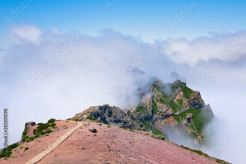 Landscape of hiking trail from Pico do Arieiro to Pico Ruivo, Madeira island, Portugal in summy summer day above the clouds photo