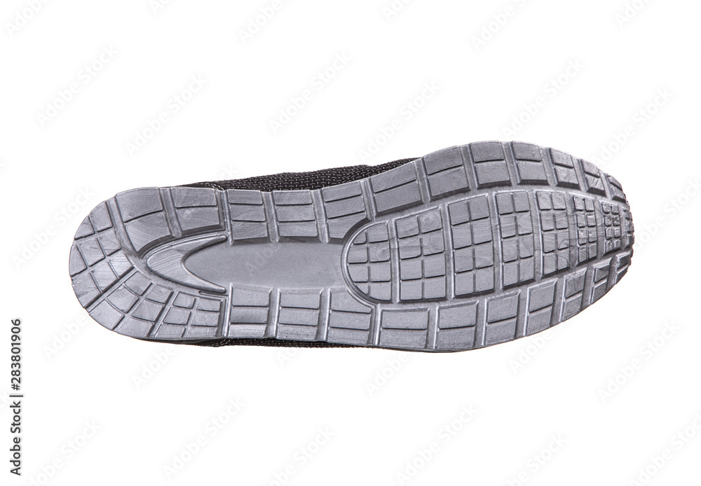 The sole of a modern sneaker is gray. Sports shoes isolate on a white background. The sole of a modern sneaker is gray. Sports shoes isolate on a white background.