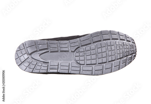 The sole of a modern sneaker is gray. Sports shoes isolate on a white background.