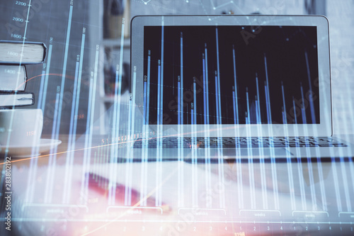 Stock market graph and table with computer background. Double exposure. Concept of financial analysis. © peshkova