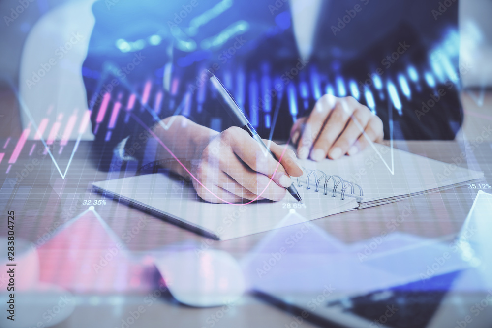 Forex graph on hand taking notes background. Concept of research. Multi exposure Forex graph on hand taking notes background. Concept of research. Multi exposure