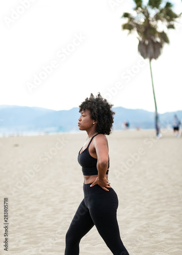 Profile of woman stretching on beach