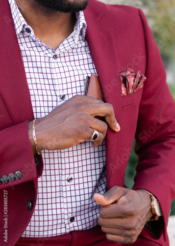 Midsection of man putting wallet in coat