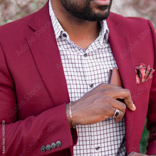 Midsection of man putting wallet in coat