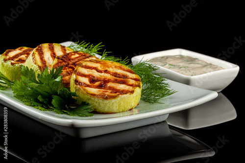 Concept for a healthy summer diet: baked zucchini with dill sauce