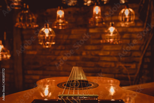  rings on the guitar with lights background photo