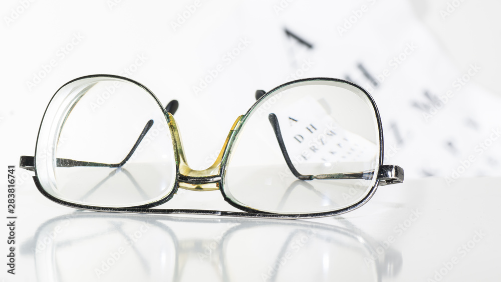 Old glasses on a table in a white room. Old glasses on a table in a white room.