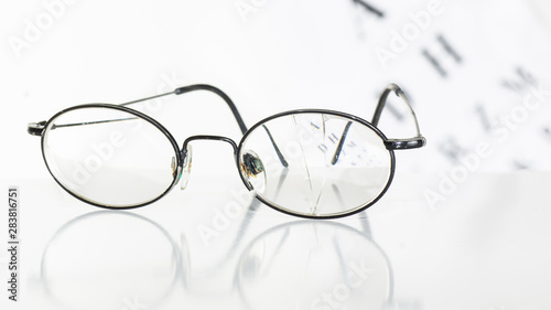 Old glasses on a table in a white room.