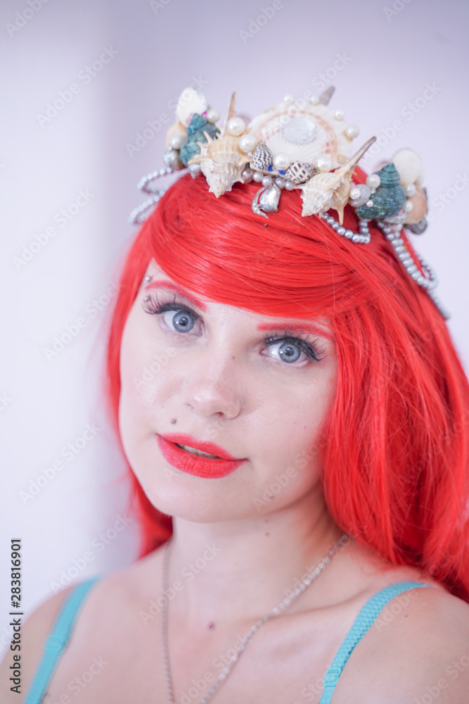 Pretty redhaired girl with seashell dreaming about vacantions. Summer travel concept. Pretty redhaired girl with seashell dreaming about vacantions. Summer travel concept.