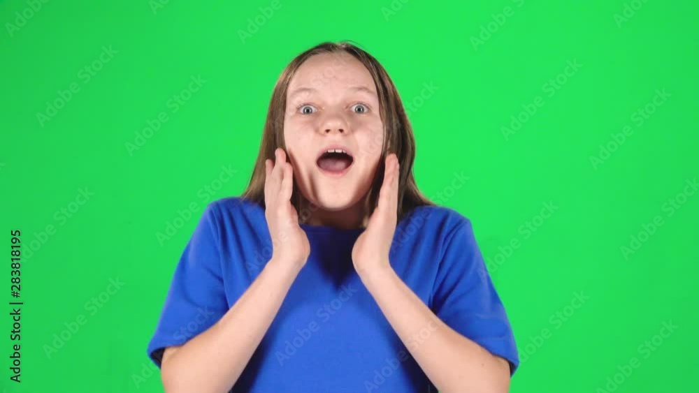 Girl is surprised and very rejoiced in studio on green screen. Slow motion Girl is surprised and very rejoiced in studio on green screen. Slow motion