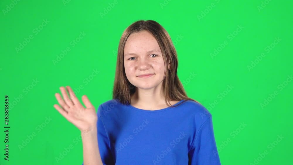 Girl is waving hello and inviting to come her on green background. Slow motion Girl is waving hello and inviting to come her on green background. Slow motion