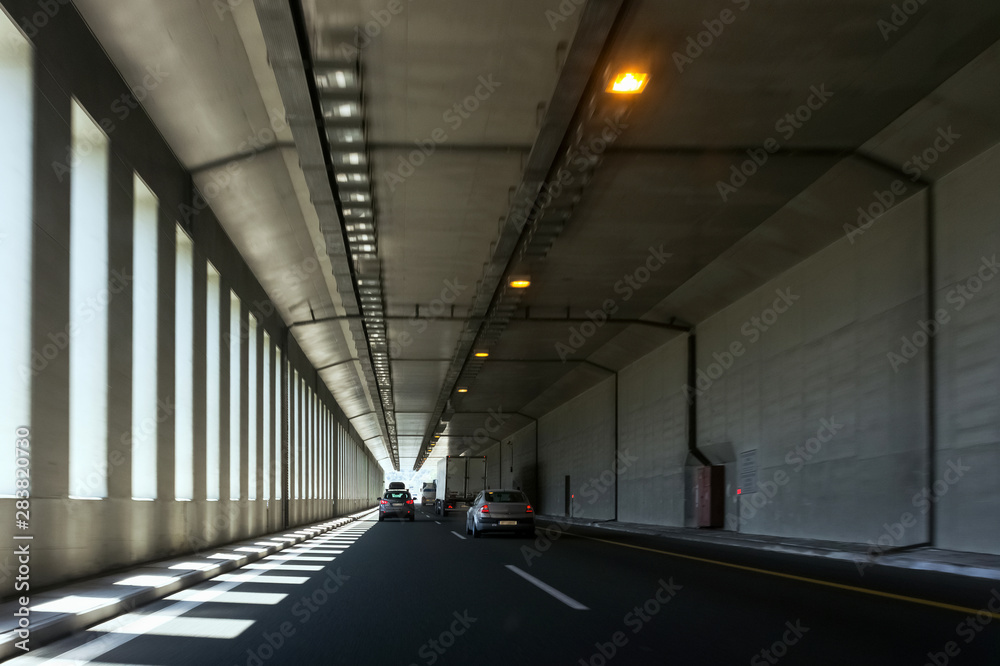 half-open tunnel with moving cars