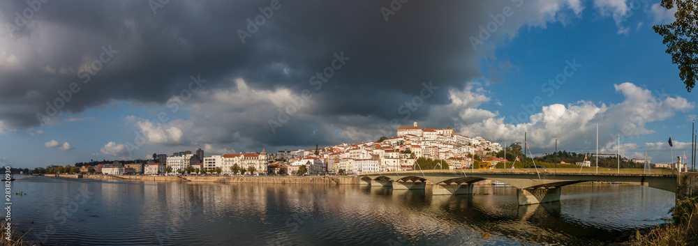 Panoramic city view from the Mondego River shore, Coimbra, Portugal