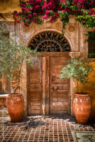 Traditional mediterranean backyard with old doors