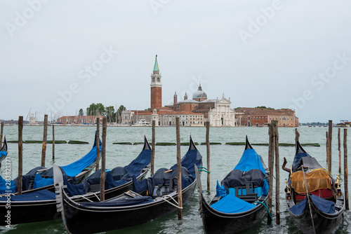 handballs parked near the shore of St. Mark s Square in Venice with a view of the water. Postcard with venetian cityscape
