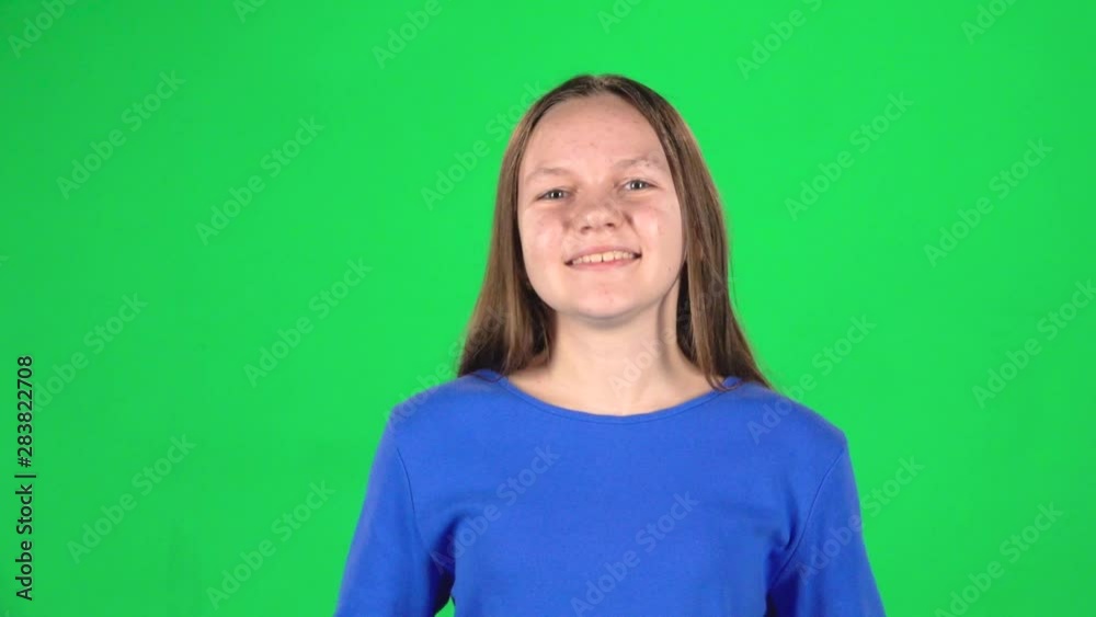 Girl is rejoiced and clapping her hands in studio on green screen. Slow motion Girl is rejoiced and clapping her hands in studio on green screen. Slow motion