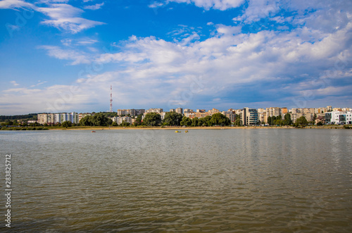 Eastern Europe Ukrainian city dirty river waterfront with building landmark ordinary view on background 