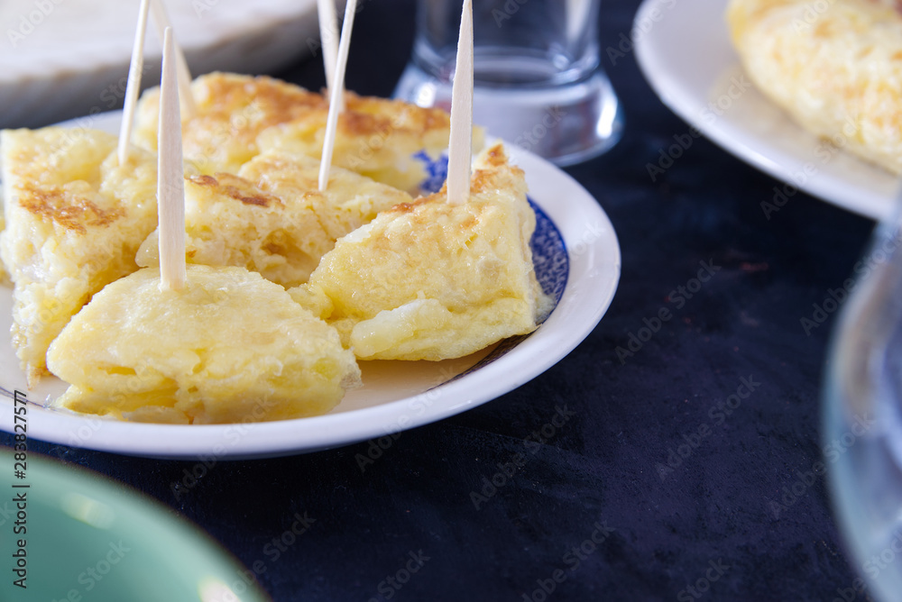 Tortilla de patatas typical Spanish omelette with potato served as tapas with toothpick. Cuisine travel with empty copy space for Editor's text.