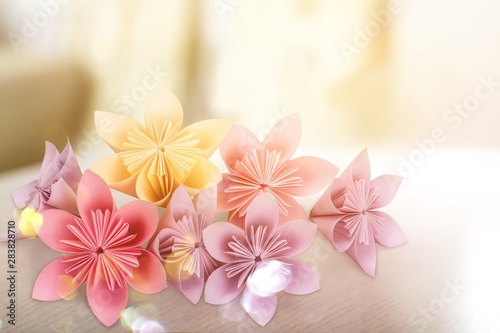 Origami flowers on white background