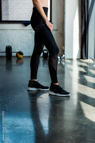 cropped view of athletic woman standing in sports wear in gym © LIGHTFIELD STUDIOS