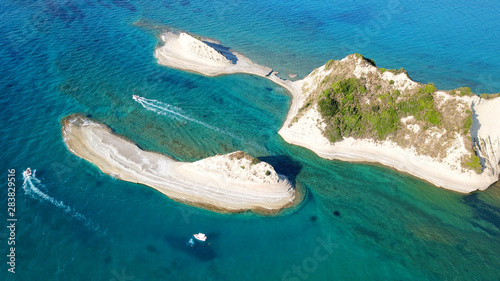 Aerial drone bird's eye view photo of iconic white rock volcanic tropical islet with emerald clear water sea © aerial-drone