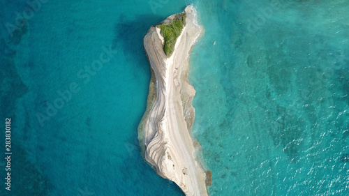 Aerial drone bird's eye view photo of iconic white rock volcanic tropical islet with emerald clear water sea