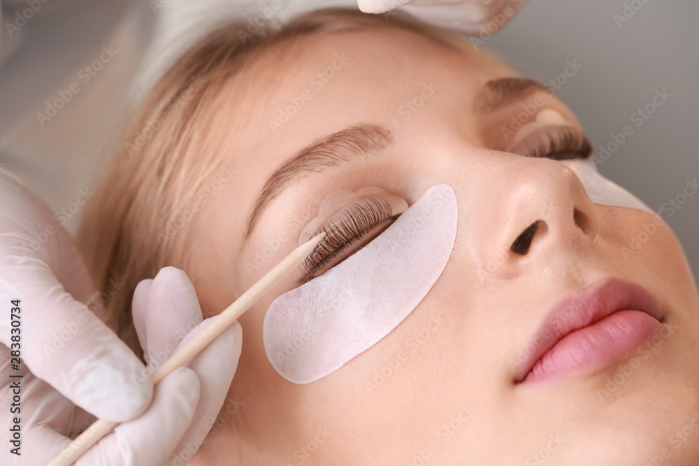 Εκτύπωση καμβά Young woman undergoing procedure of eyelashes lamination in beauty salon, closeu