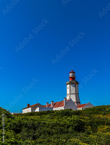 Cape Espichel Lighthouse. Situated on the western coast of the civil parish of Castelo, municipality of Sesimbra, in the Setúbal district of Portugal © Rui