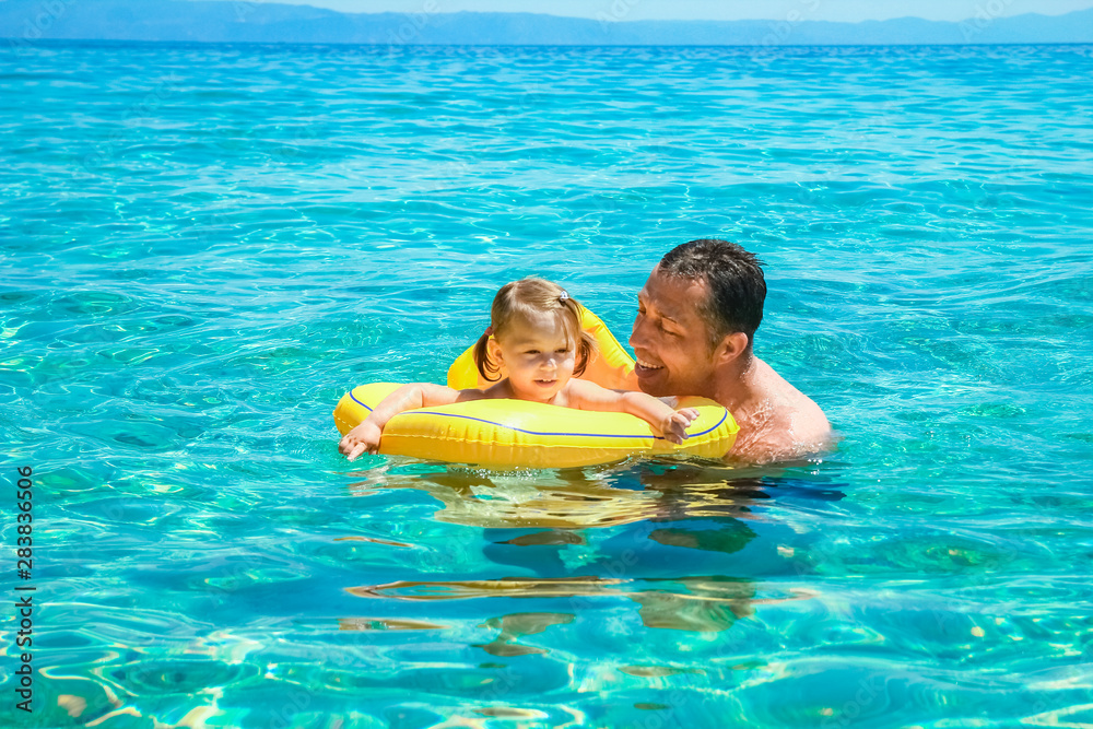 happy parent with child at sea in greece