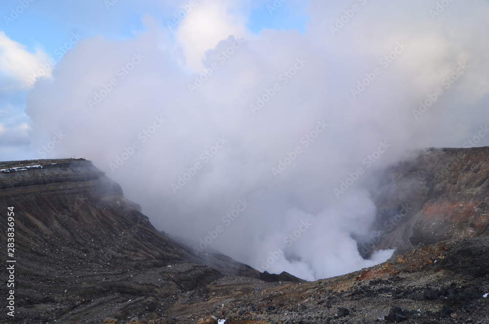 Japan's active volcano Mount Aso erupting with white smoke