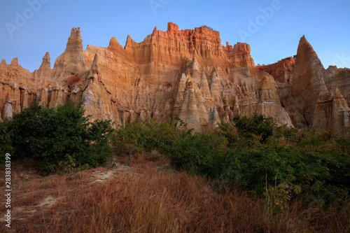 Earth Forest of Yuanmou in Yunnan Province, China - Exotic earth and sandstone formations glowing in the sunlight. Naturally formed pillars of rock and clay with unique erosion patterns. China Travel