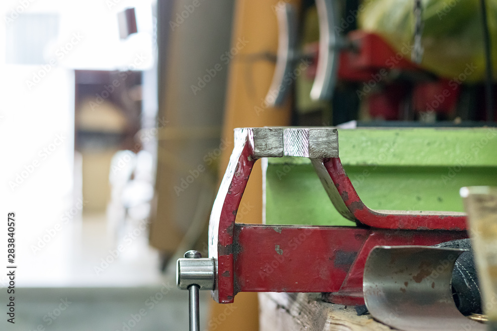 A vise for shoemaker closeup inside a workshop.