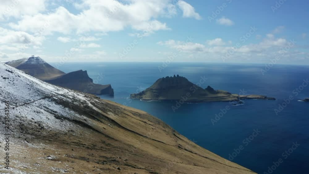 The mountains with a small trail, snow and the ocean The mountains with a small trail, snow and the ocean