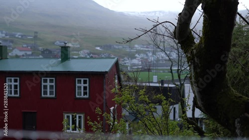 Small village in the rain with woodhouses photo