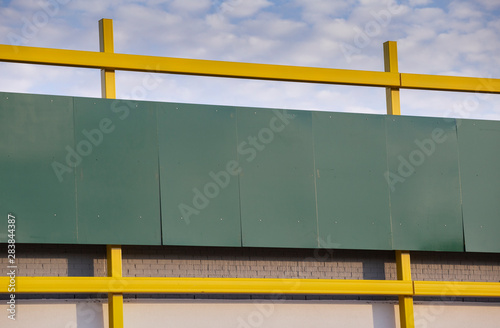 Blank Green Store Front on Blue Sky