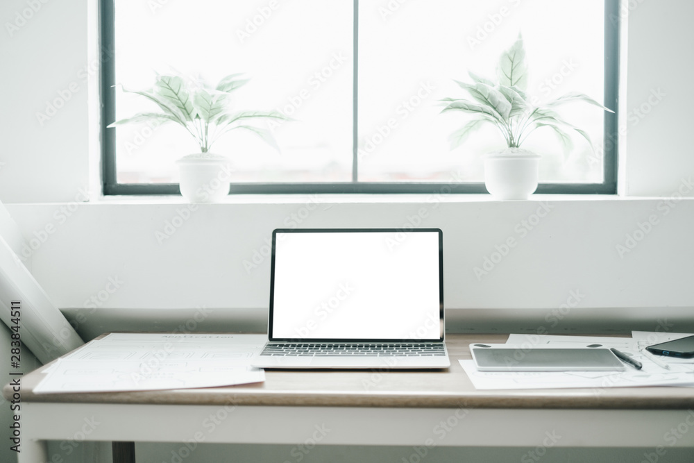 Mockup image of laptop on wood table with equipment of the mobile application graphic designer, mockup concept