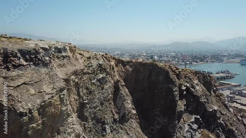 Aerial shot of top cliff near a coastal town