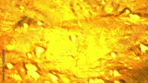 Motion graphic of a golden water flowing effect for background footage usage photo