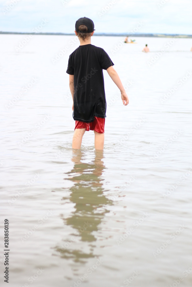boy walking on the beach boy walking on the beach