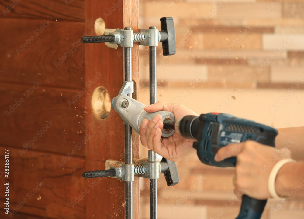 Drilling and installation of new lock on the wooden door