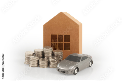 Car and house model with stack of  coins photo