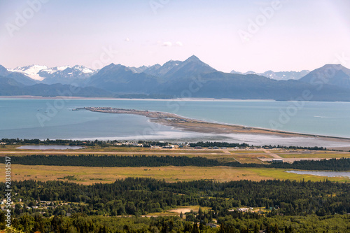 An elevated view of the Homer Spit and Kachemak Bay in Homer, Alaska during a summer day. photo