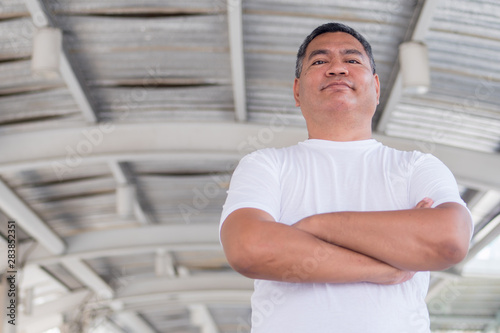 confident asian old man crossing arm portrait