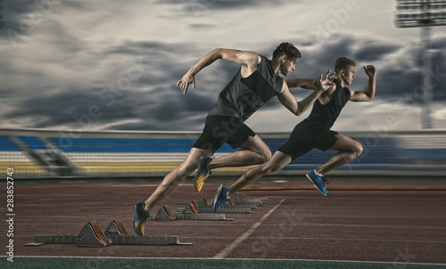 Two man sprinter leaving starting blocks © Andrey Burmakin